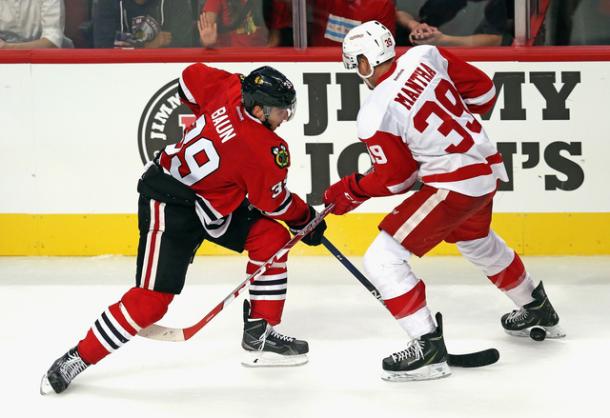 Kyle Baun (39) of Chicago pokes the puck through Anthony Mantha (39) during the preseason, Photo via: Jonathan Daniel/Getty Images