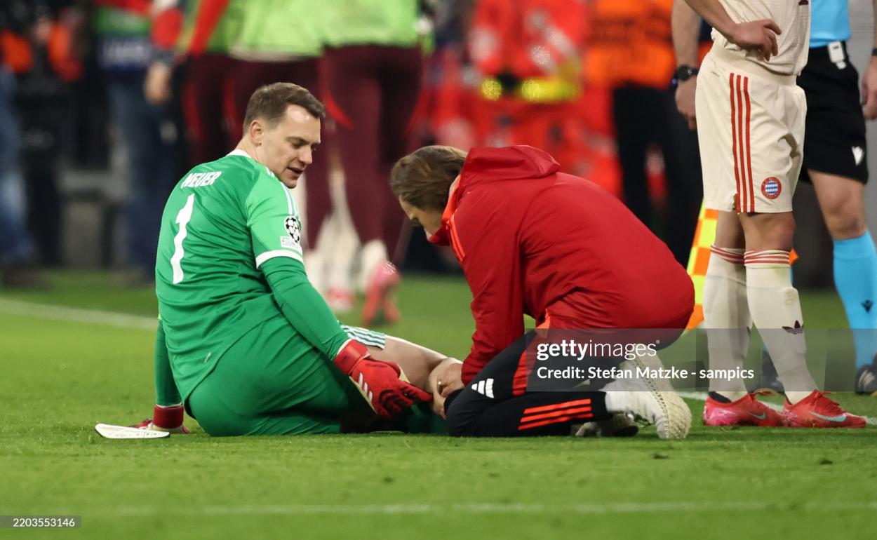 Manuel Neuer reçoit un traitement pour une blessure lors du match contre Bayer Leverkusen. Photo de Stefan Matzke - Sampics / Getty Images