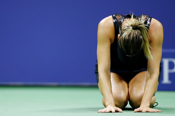 Maria Sharapova falls to the ground in tears of joy after grabbing the win | Photo: Clive Brunskill/Getty Images North America