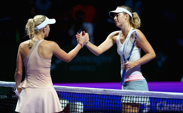 Maria Sharapova shakes hands with Caroline Wozniacki after her loss in 2014 at the WTA Finals | Photo: Clive Brunskill/Getty Images AsiaPac