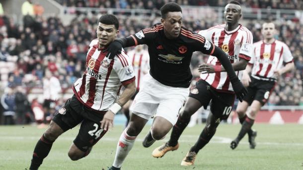 Above: Deandre Yedlin tussling with Manchester United's Anthony Martial after stating that his defending has improved since his move to Sunderland