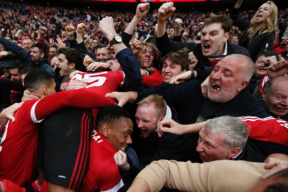 Anthony Martial is mobbed after scoring the winning goal in the 93rd minute | Photo: Adrian Dennis/AFP