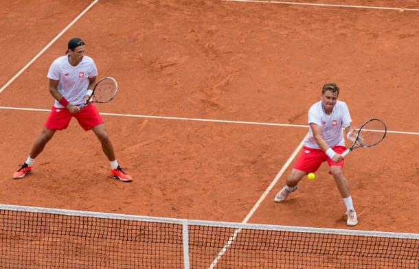Matkowski (right) hits a volley as Kubot watches. Photo: Davis Cup