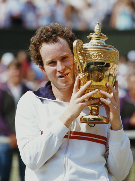 John McEnroe holds his 1984 Wimbledon trophy. Photo: Trevor Jones/Getty Images