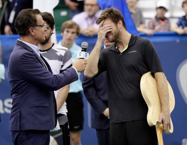 An emotional Harrison holds back tears after being presented with the winner's trophy/Photo: Mark Humphrey/Associated Press