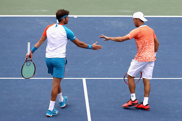 Radu Albot and Malek Jaziri high five after winning a point (Photo: Al Bello/Getty Images)