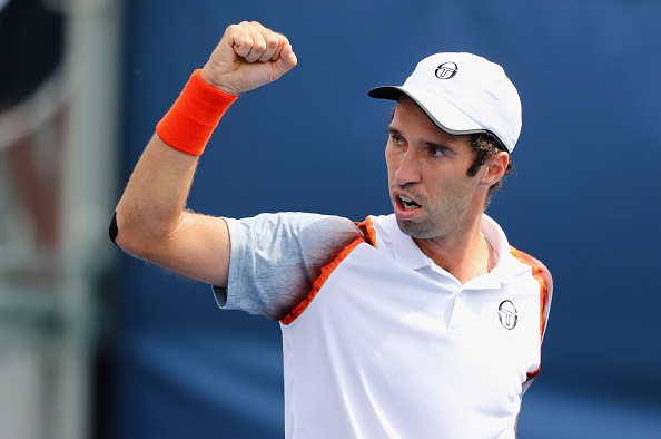Mikhail Kukushkin pumps his fists after taking the opening set (Photo: Elsa/Getty Images)