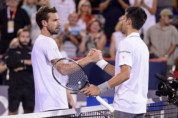 Ernests Gulbis and Novak Djokovic meet at the net after their match at the Rogers Cup in 2015 (Getty/Minas Panagiotakis)