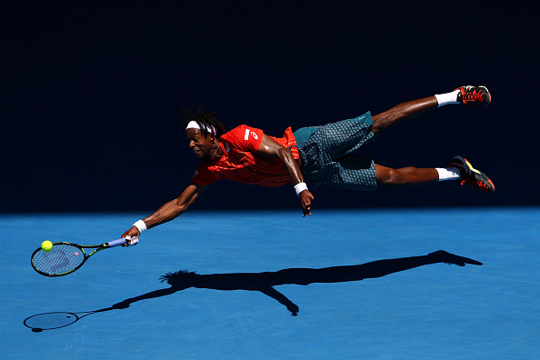 Gael Monfils dives for a shot during his fourth round match. Photo: Cameron Spencer/Getty Images