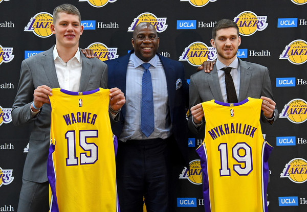 Magic Johnson, the Los Angeles Lakers president of basketball operations, stands with the team's 2018 NBA draft picks Moritz Wagner and Sviatoslav Mykhailiuk during an introductory press conference |Jayne Kamin-Oncea/Getty Images North America|