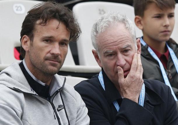 Carlos Moya (left) and John McEnroe discuss during Raonic's fourth round loss in Paris. Photo: AP