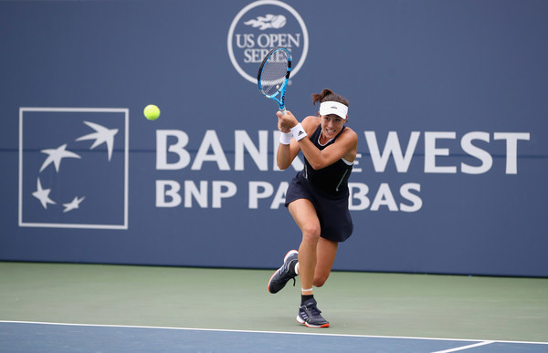 Muguruza chases down a backhand. Photo: Ezra Shaw/Getty Images