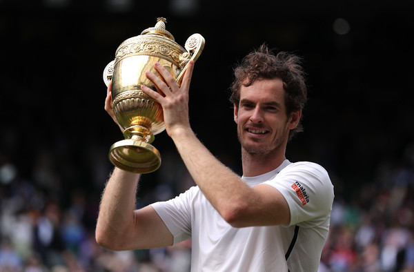 Andy Murray hoists his trophy last year at Wimbledon. Photo: Getty Images