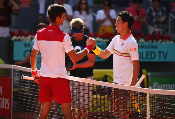 Djokovic and Nishikori embrace at the net (Image source: Clive Brunskill/Getty Images Europe)