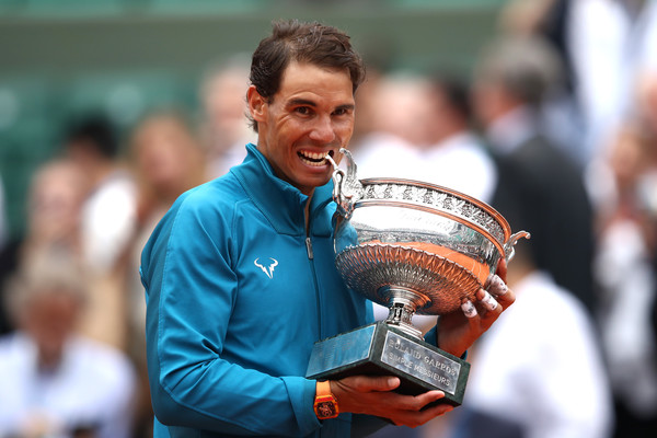 Nadal bites into his 11th Roland Garros trophy earlier this month. Photo: Cameron Spencer/Getty Images