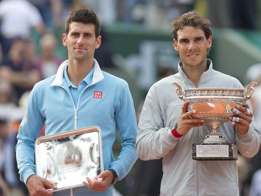 Nadal (left) and Novak Djokovic pose with their trophies after the 2014 French Open final. Photo: Susan Mullane/USA Today Sports