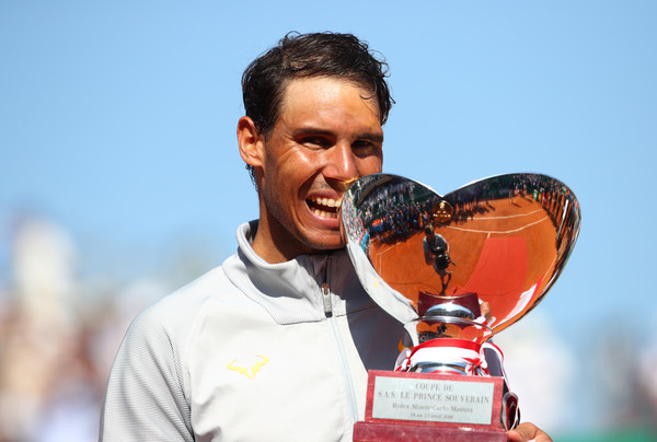 Nadal bites his 11th trophy in Monte Carlo. Photo: Julian Finney/Getty Images