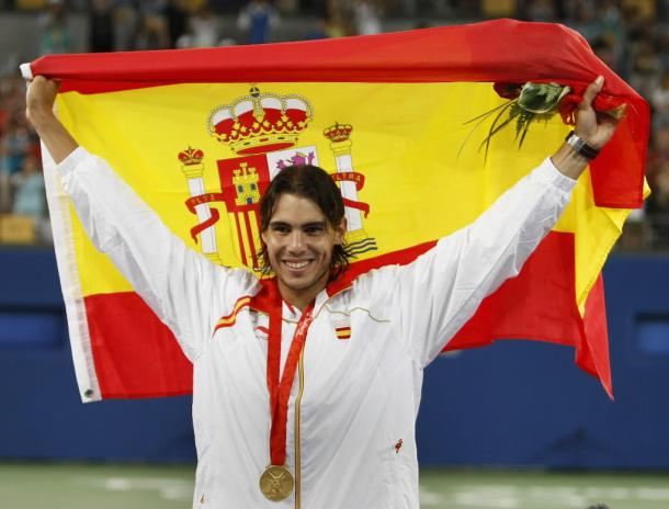 Nadal hoists the flag after his win at the Olympics in 2008. Photo: Clive Brunskill/Getty Images