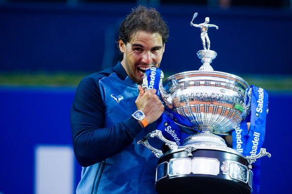 Rafael Nadal bites his Barcelona Open trophy after claiming the title in April. Photo: Alex Caparros/Getty Images