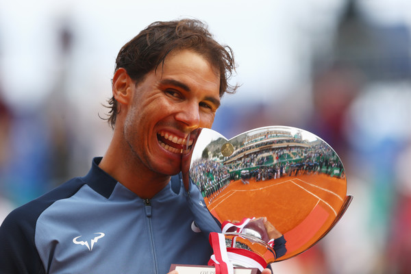 Rafael Nadal bites his 2016 Monte Carlo Rolex Masters trophy. Photo: Michael Steele/Getty Images