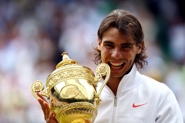 Nadal bites his 2010 Wimbledon trophy, his last victory at the All England Club. Photo: Julian Finney/Getty Images