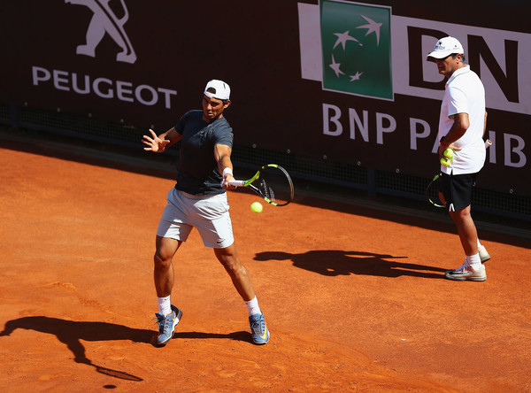 Rafael Nadal (left) hits a ball in practice as Toni Nadal watches at the French Open. Photo: Matthew Lewis/Getty Images