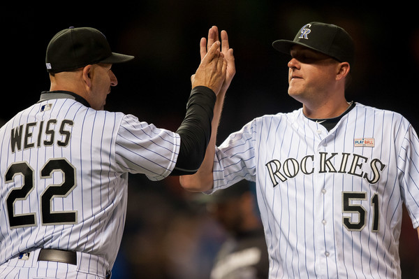 Rockies manager Walt Weiss congratulates closer Jake McGee after he secured the team's win over the New York Mets (Dustin Bradford/Getty Images)