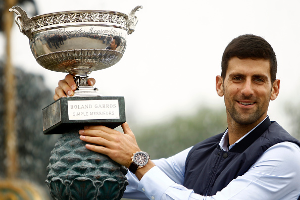 Djokovic  celebrates the victory in Paris and poses for the photographers with the trophy in front of the fountain at the concord near Champs Elysees in Paris, on June 6, 2016. (Photo by Mehdi Taamallah/NurPhoto via Getty)