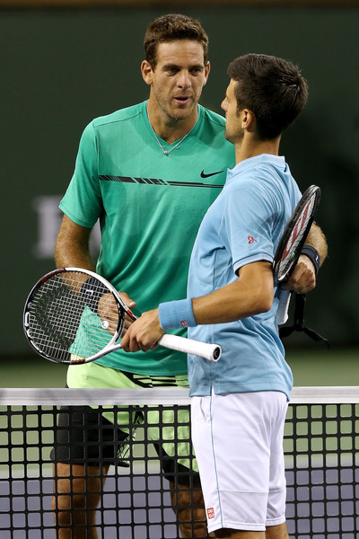 Both players meet at the net after the match | Photo: Matthew Stockman/Getty Images North America