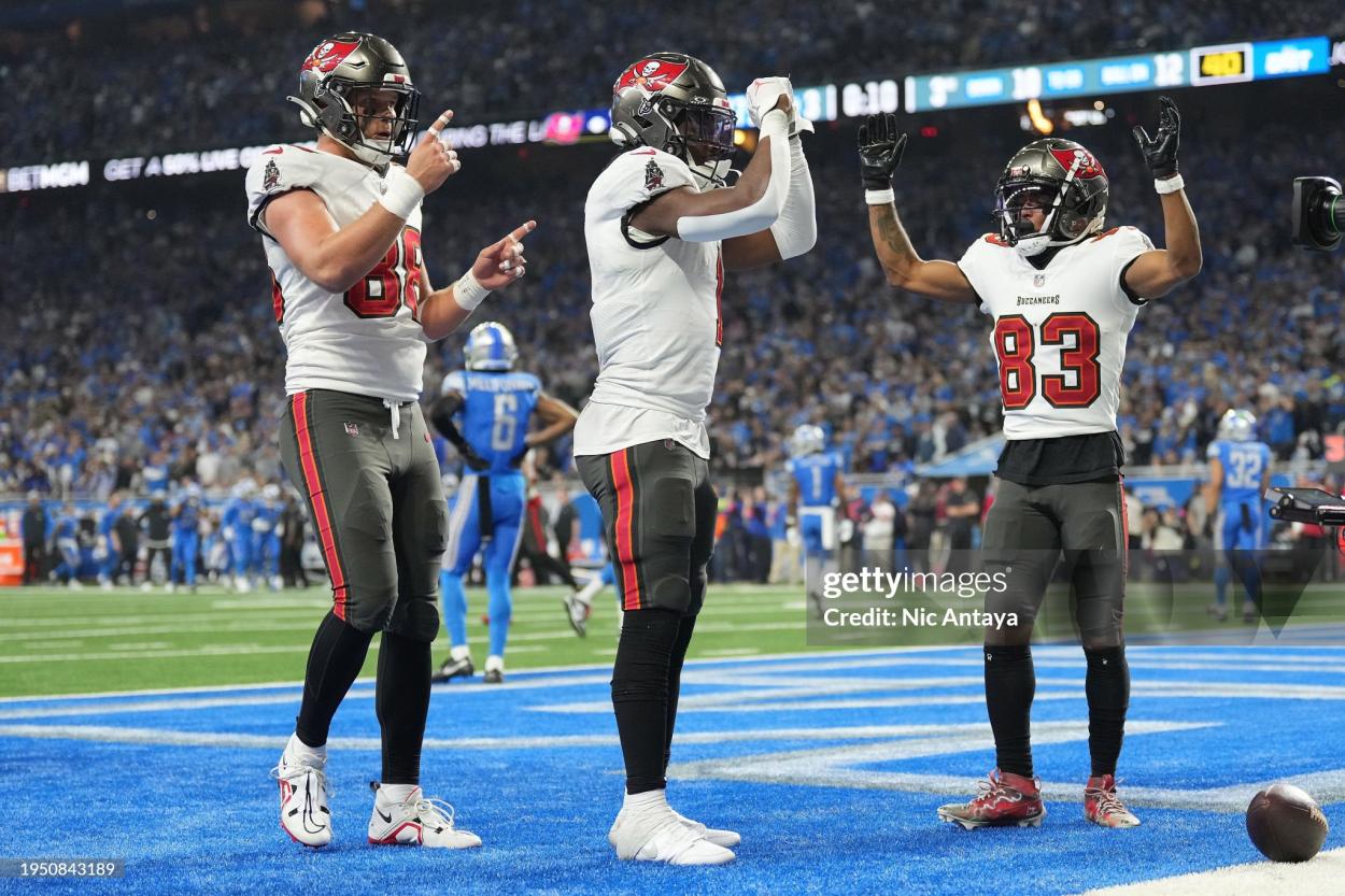 Rachaad White #1 of the Tampa Bay Buccaneers celebrates a touchdown with <strong><a  data-cke-saved-href='https://www.vavel.com/en-us/nfl/2020/10/07/1040880-atlanta-falcons-mock-draft-10.html' href='https://www.vavel.com/en-us/nfl/2020/10/07/1040880-atlanta-falcons-mock-draft-10.html'>Cade Otton</a></strong> #88 and Deven Thompkins #83 against the Detroit Lions during the second half of the NFC Divisional Playoff game at Ford Field on January 21, 2024 in Detroit, Michigan. (Photo by Nic Antaya/Getty Images)
