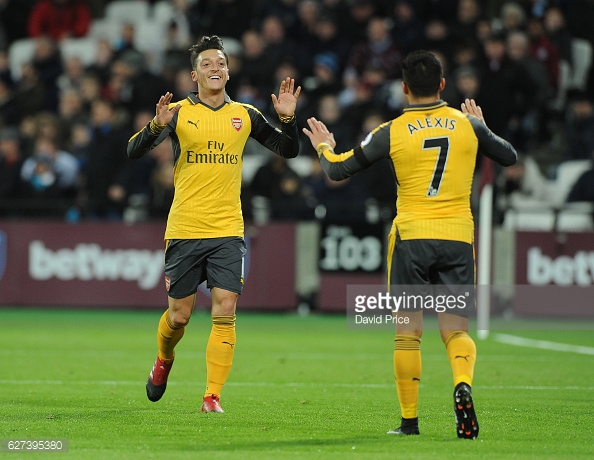 Ozil and Sanchez celebrating Arsenal's opening goal in their 5-1 win away at West Ham in December. (Image By Getty Images/David Price)