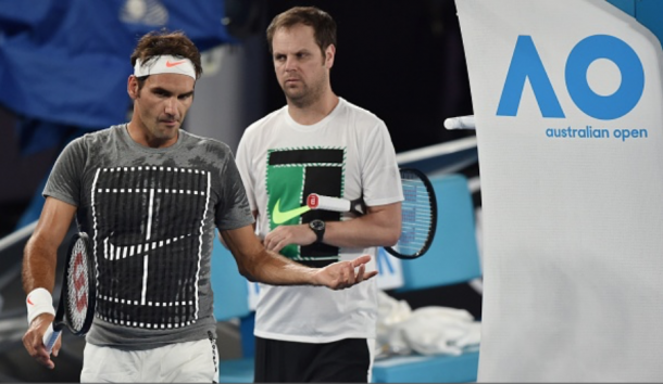 Federer chats with his coach Severin Luthi during a practice session on Rod Laver Arena. Credit: Paul Crock/AFP/Getty Images