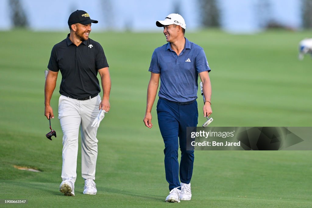 Xander Schauffele and Collin Morikawa smile as they walk up the fourth hole fairway during the first round of The Sentry on The Plantation Course at Kapalua on January 4, 2024 in Kapalua, Maui, Hawaii. (Photo by Ben Jared/PGA TOUR via Getty Images)