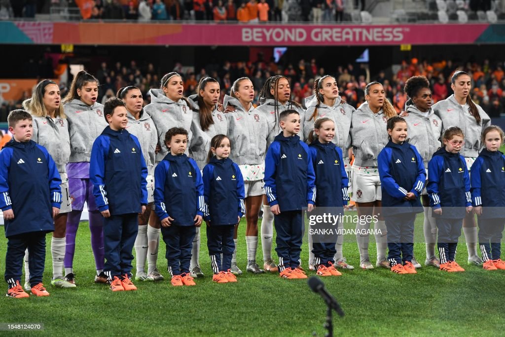 Portugal players stand for their national anthem prior to the start of the Australia and New Zealand 2023 Women's <strong><a  data-cke-saved-href='https://www.vavel.com/en/football/2023/07/22/womens-football/1151489-usa-3-0-vietnam-smith-at-the-double-as-stars-and-stripes-open-world-cup-campaign-in-style.html' href='https://www.vavel.com/en/football/2023/07/22/womens-football/1151489-usa-3-0-vietnam-smith-at-the-double-as-stars-and-stripes-open-world-cup-campaign-in-style.html'>World Cup</a></strong> Group E football match between the Netherlands and Portugal at Dunedin Stadium in Dunedin on July 23, 2023. (Photo by Sanka Vidanagama / AFP) (Photo by SANKA VIDANAGAMA/AFP via Getty Images)