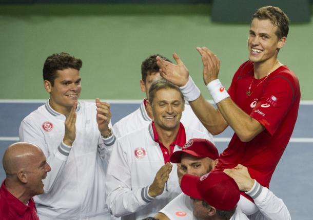 Vasek Pospisil (in red) is hoisted onto his teammates shoulders after sealing Canada's victory in the 2015 Davis Cup first round. Photo: Rick Ernst/Postmedia