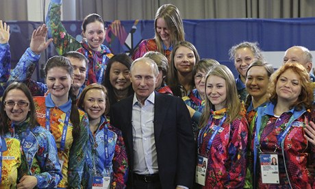 Vladimir Putin with volunteers during the 2014 Winter Olympics in Sochi. Photo: Sasha Mordovets/Getty