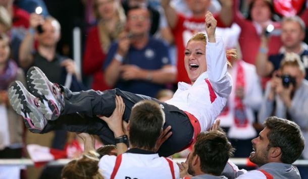 Radwanska is hoisted into the air by her teammates after sending Poland to the World Group in 2014. Photo: Fed Cup