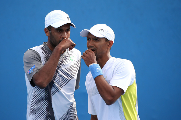 Rajeev Ram (left) and Raven Klaasen discuss strategy during their second roumd match (Photo: Getty Images)