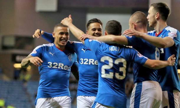 Rangers players celebrate winning the title. Source: The Guardian.