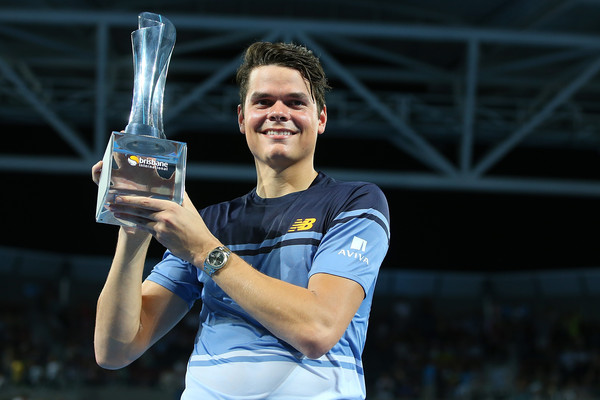 Raonic hoists the trophy in Brisbane. Photo: Chris Hyde/Getty Images