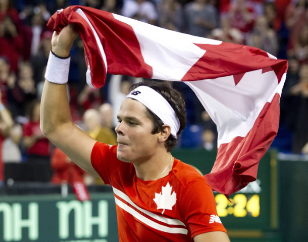 Milos Raonic waves the flag after Canada defeated Italy in the 2013 Davis Cup Quarterfinals. Photo: Davis Cup