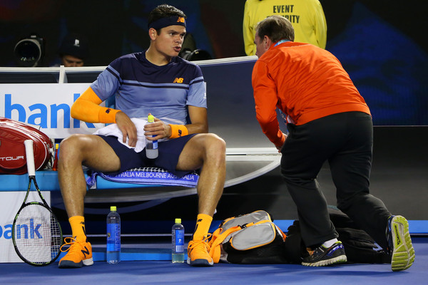 Milos Raonic talks to the doctors during his Australian Open semifinal. Photo: Michael Dodge/Getty Images