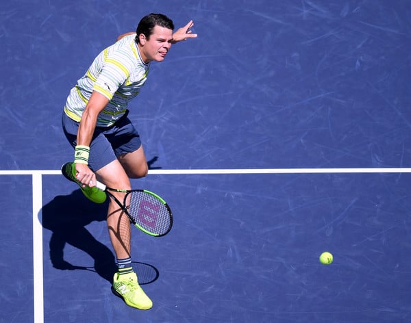 Milos Raonic volleys during one of his 34 net attacks during the quartefinal win. Photo: Harry How/Getty Images