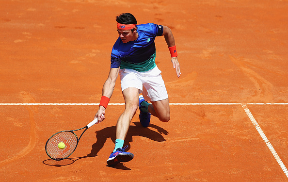 Milos Raonic slides into a forehand. Photo: Matthew Lewis/Getty Images