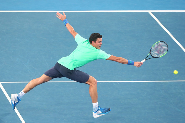 Milos Raonic lunges for a backhand volley. Photo: Chris Hyde/Getty Images