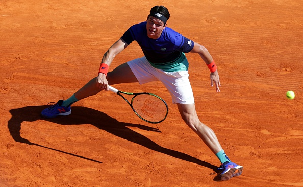 Milos Raonic slides into a forehand. Photo: Jean Christophe Magnet/Getty Images