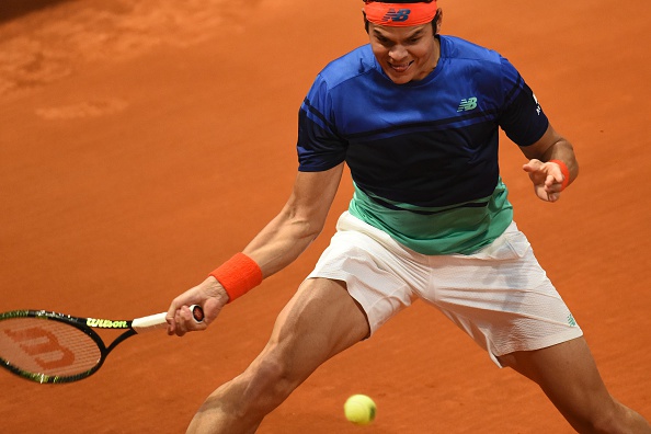 Raonic slides into a forehand. Photo: Pedro Armestre/AFP/Getty Images