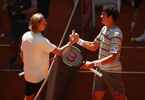 Shapovalov (right) and Raonic shake hands after the first meeting between Canadian tennis' future and present. Photo: Clive Brunskill/Getty Images