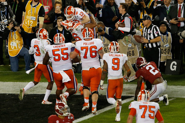 Renfrow (13) is mobbed by his teammates after scoring the touchdown that delivered Clemson their first title in 35 years/Photo: Brian Blanco/Getty Images