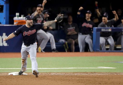 Mike Napoli, shadowed by his team's jubilant dugout, celebrates the final out of Game 3 (AP Photo/Charlie Riedel)